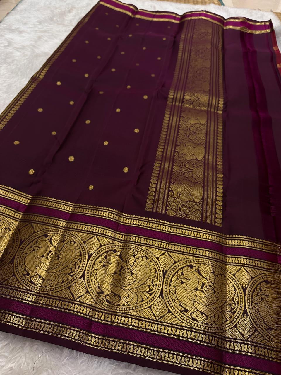 Antique mustard gold Kanchipattu saree with sorgavaasal mayil peacock border detail