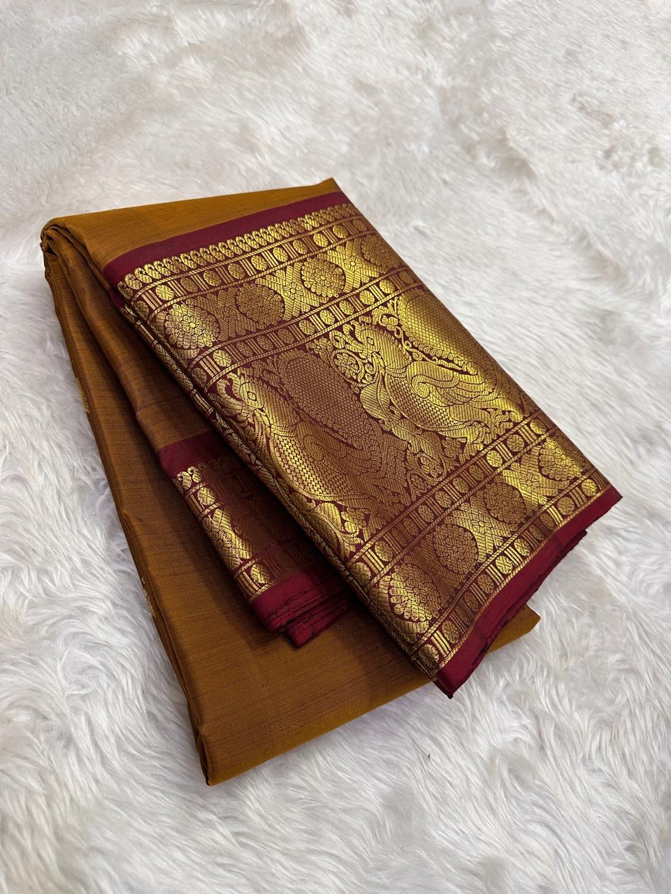 Close view of Kamalam zari buttas on mustard-gold Kanchipuram silk.