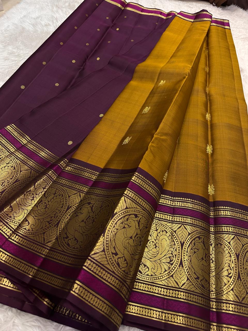 Mustard gold Kanchipuram silk saree with sorgavaasal mayil peacock motif detail