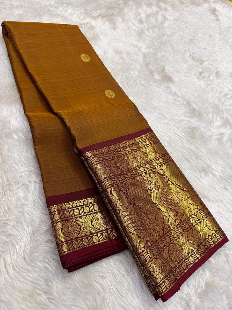 Mustard-gold Pure Silk Kanchipuram Zari Kattam saree.