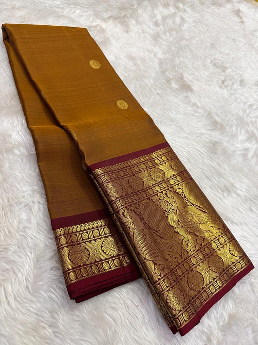 Mustard gold Kanjeevaram saree with burgundy red korvai mayil border – detail view