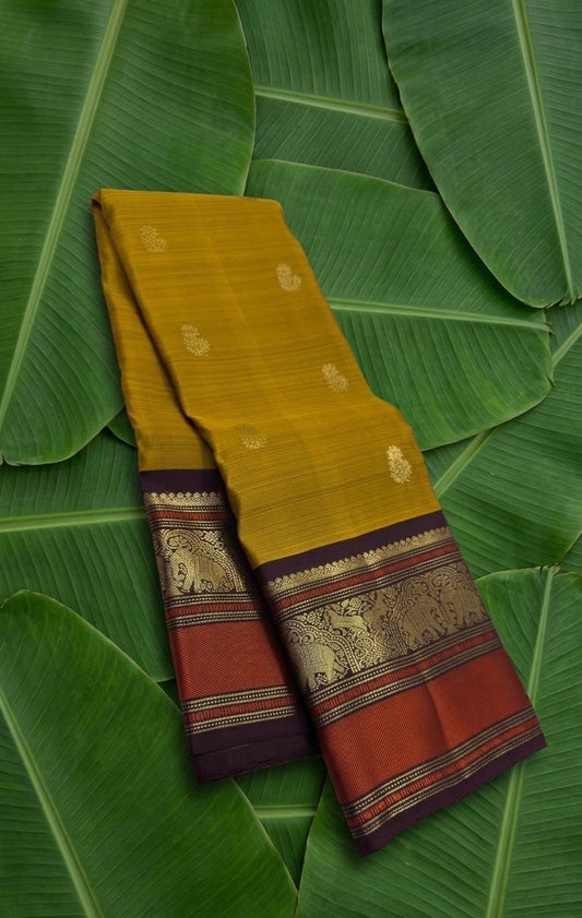 Mustard handwoven pure silk Kanchipuram saree with Varisaipet Vanasringaram border — full folded overview