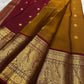 Mustard Kanjivaram saree with an ornate Arakku peacock border.