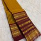 Deep Arakku Kanchipuram pallu showing dense geometric gold zari latticework and floral ornamentation.