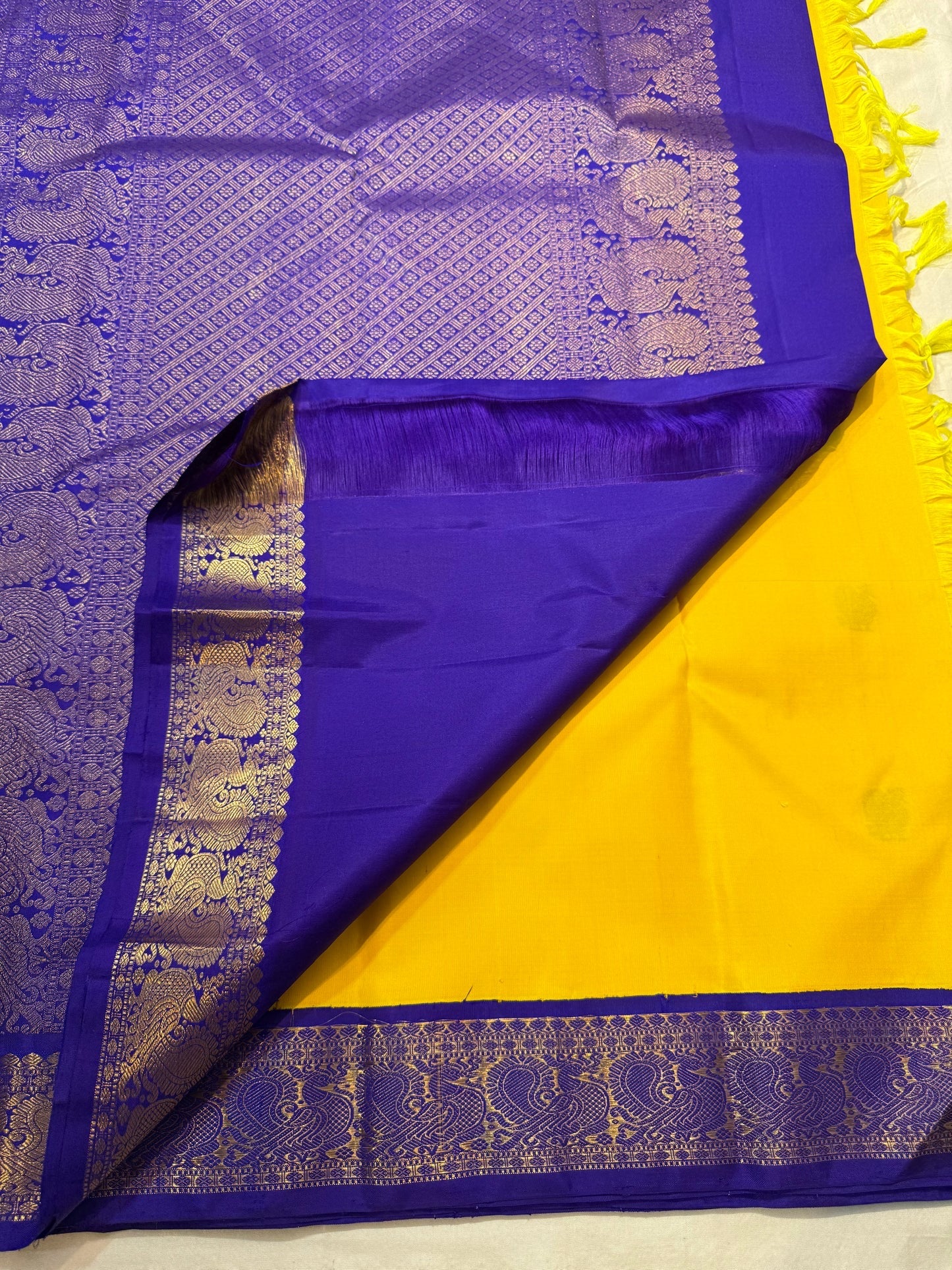 Close-up of navy silk thread butta on mustard yellow Kanchipuram pure silk saree — Idam Living