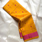 Folded mustard yellow Kanchipuram silk saree with magenta checks and magenta zari woven border