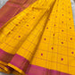 Full saree view with mustard yellow checked body, tassels, and contrasting pink zari woven pallu
