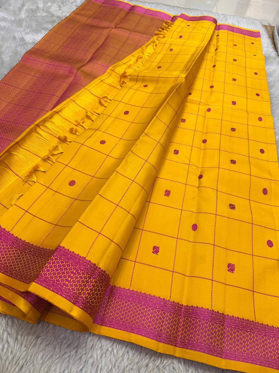 Full saree view with mustard yellow checked body, tassels, and contrasting pink zari woven pallu