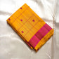 Folded mustard yellow Kanchipuram silk saree with magenta checks and magenta zari woven border