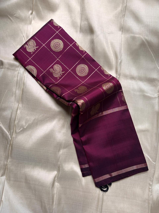 Partially draped plum Pure Kanchipuram silk saree with zari checked body, scattered woven motifs, and slim zari border.