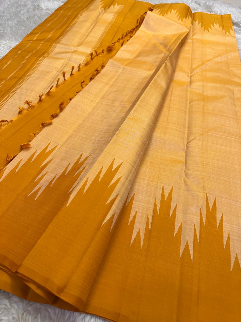 Spread Pure Kanchipuram Silk Saree with mustard body, beige panel, repeated temple motif pattern, and tasseled edge