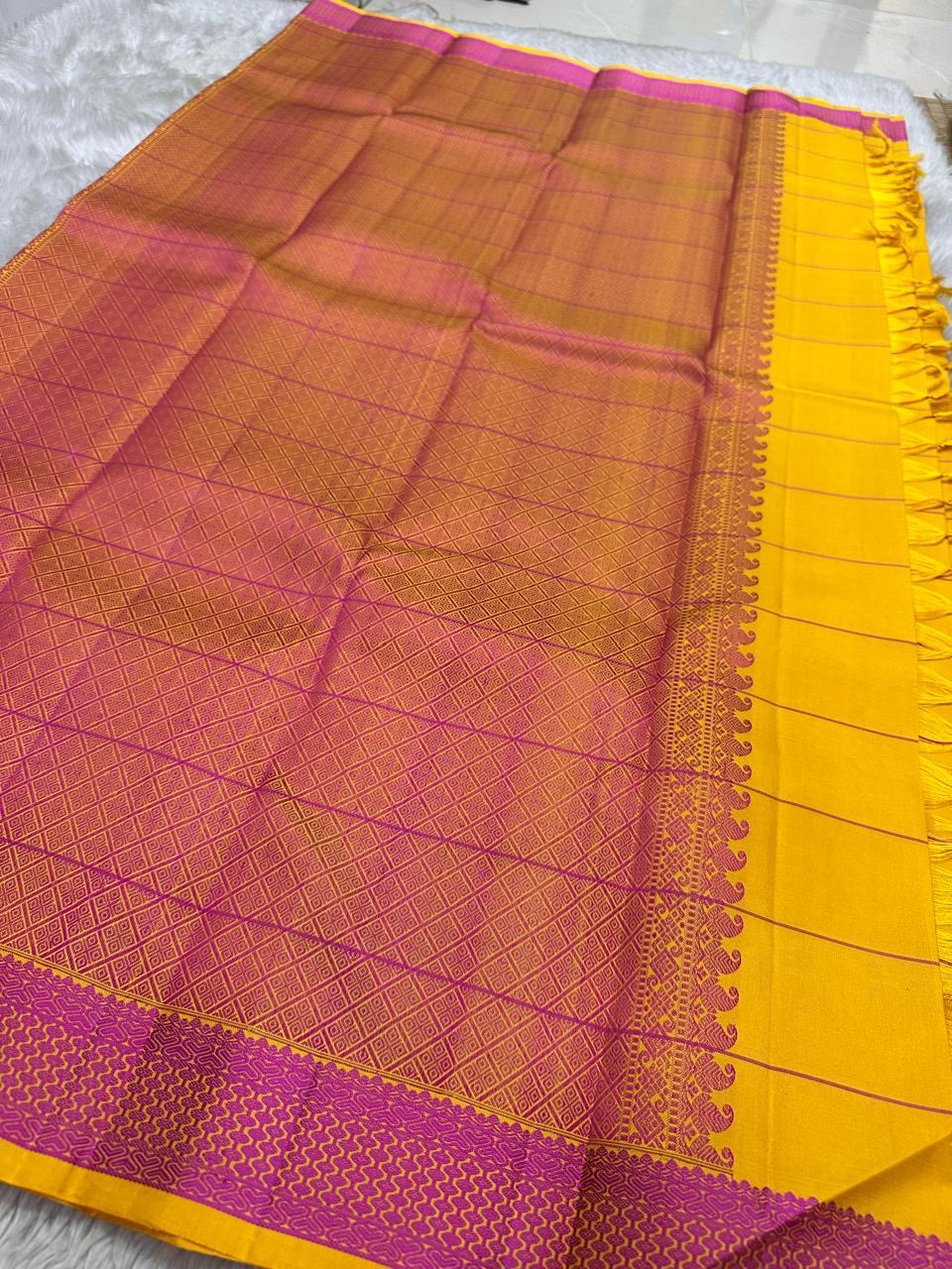 Contrasting pink zari woven pallu with geometric pattern beside mustard yellow checked saree, available in the USA
