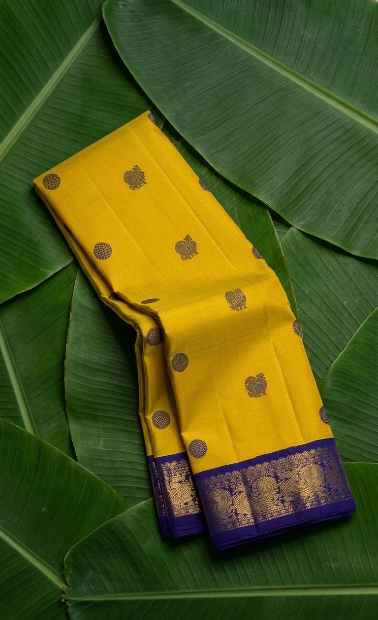 Mustard yellow handwoven Kanchipuram pure silk saree with silk thread mayil butta and royal blue korvai border — Idam Living