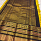 Close-up of mustard yellow silk body with luminous Zari Kattam grid and gold zari butta motifs