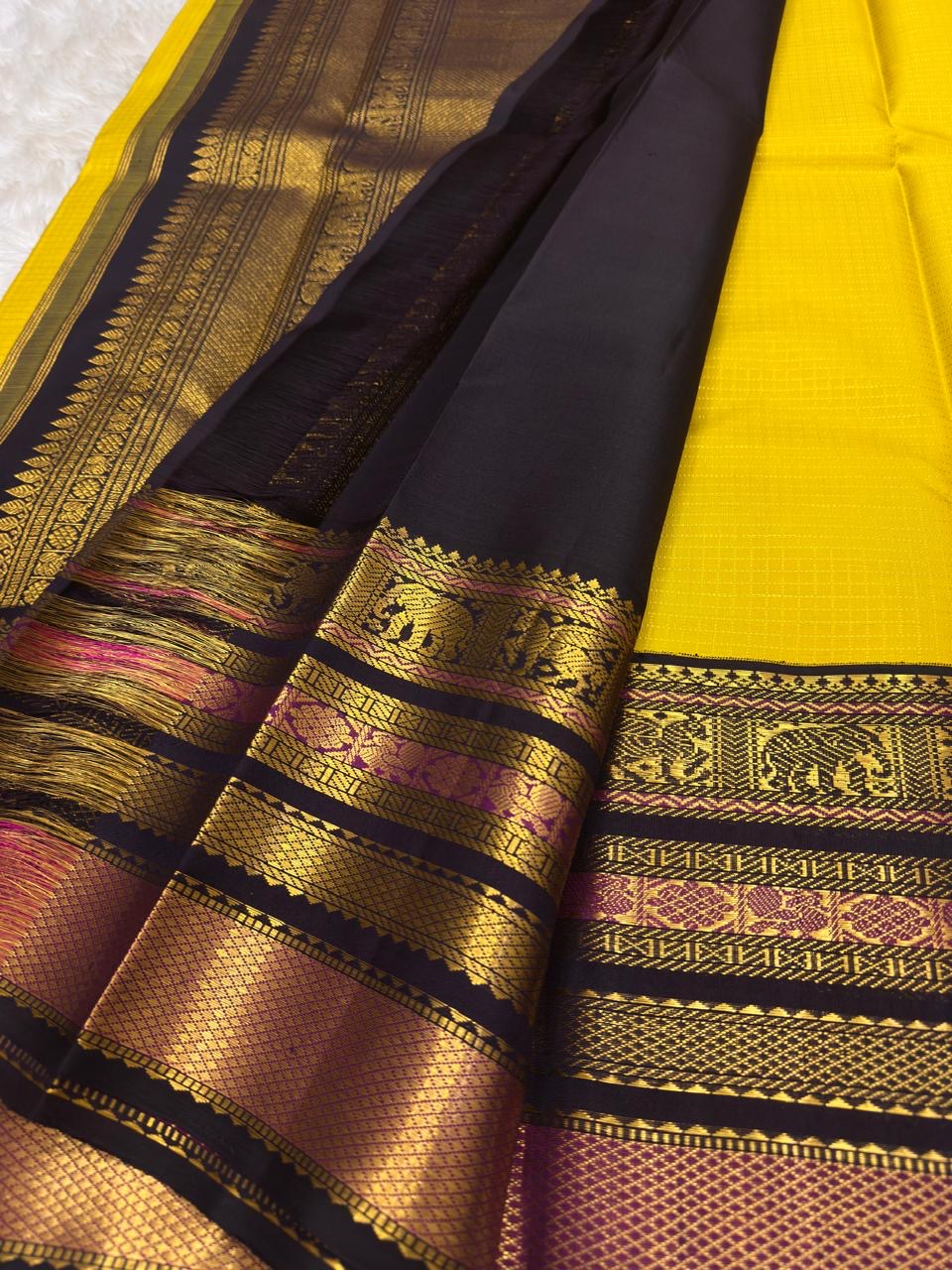 Black pallu with array of elephant, floral medallion, and chevron zari motifs cascading across full width