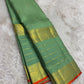 Handwoven Sage Green Varisaipet saree with layered antique-gold traditional border.