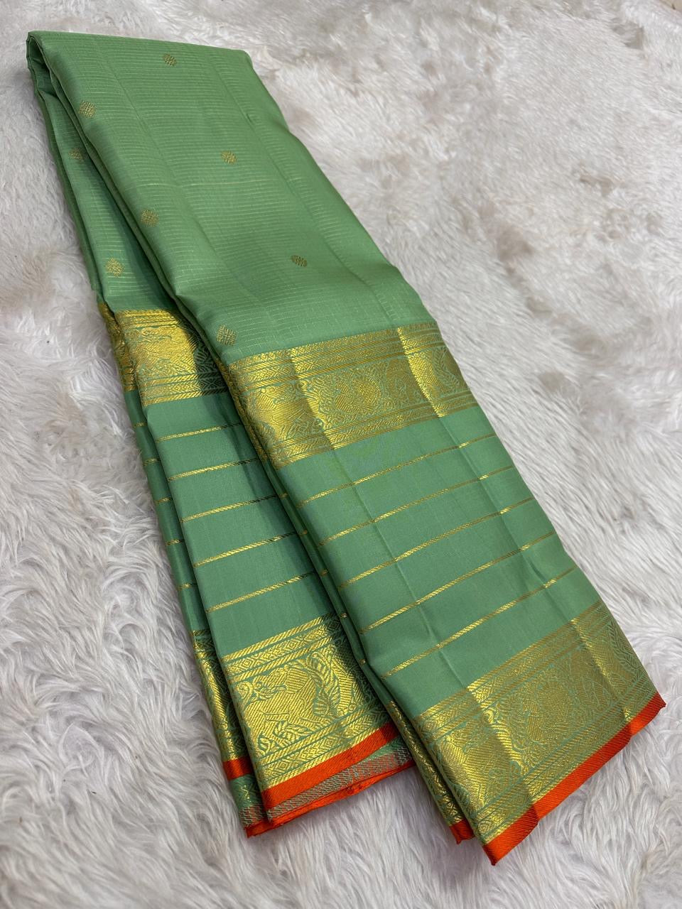 Handwoven Sage Green Varisaipet saree with layered antique-gold traditional border.