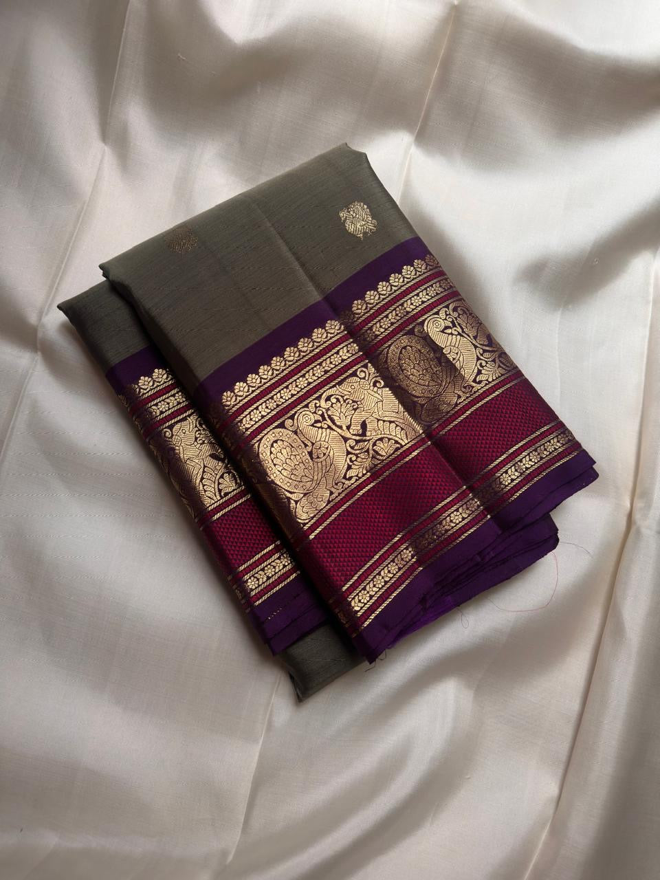 Olive Green Kanjivaram saree with ornate Royal Purple Mayil motif border