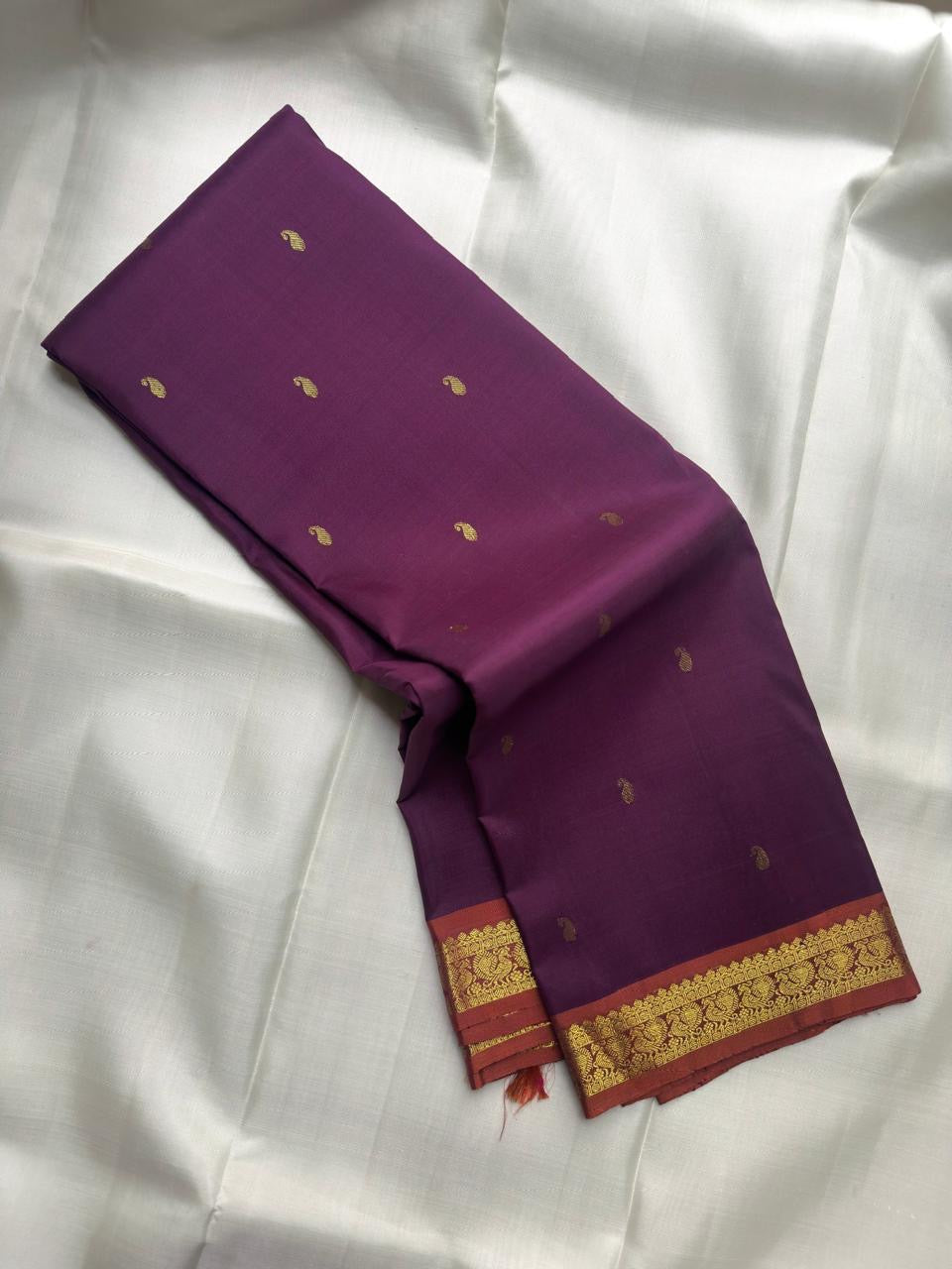 Muted Plum Purple handwoven pure silk Kanjivaram Butta saree with antique-gold paisley buttas.