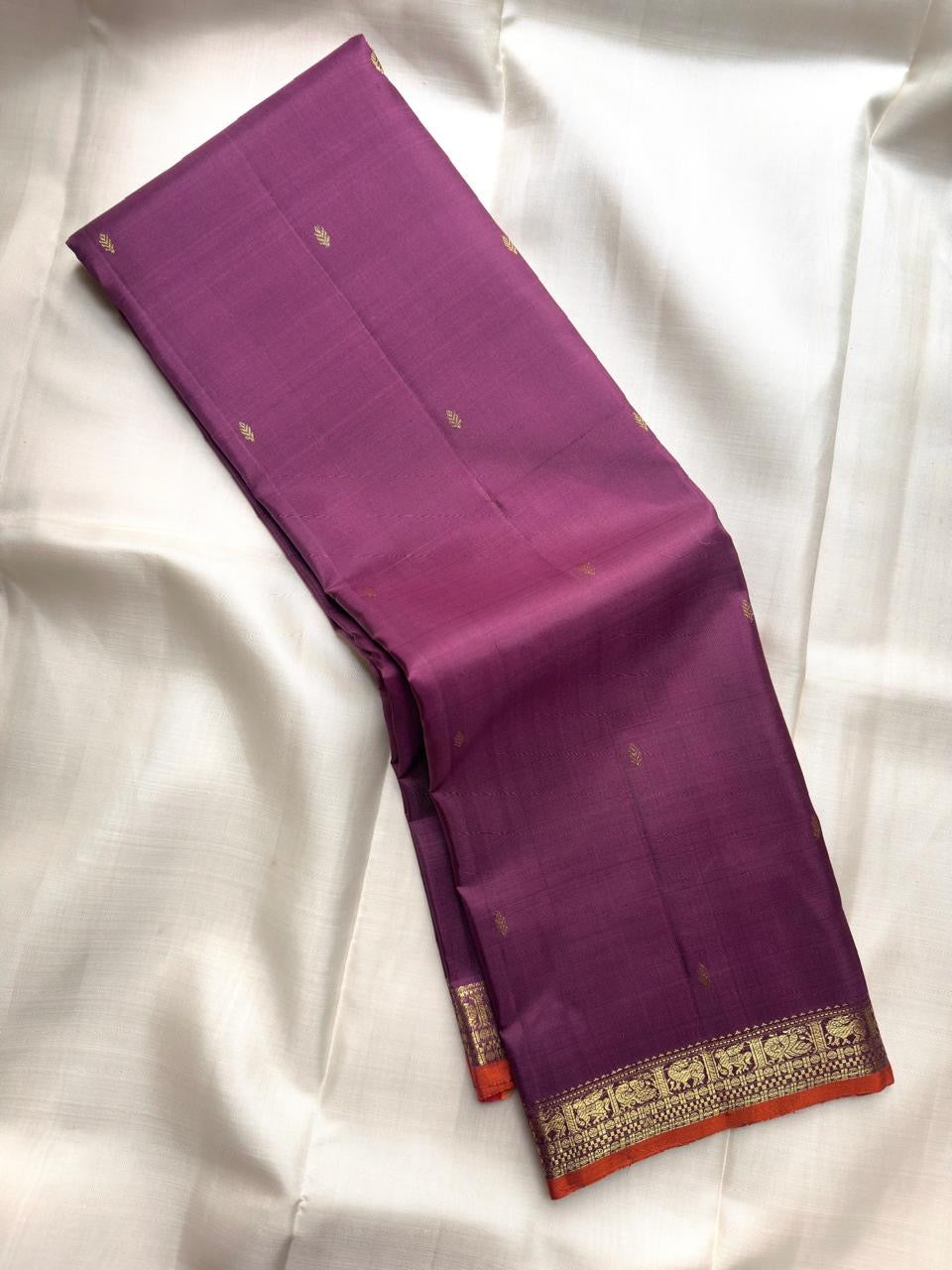 Muted Vadamalli Purple handwoven pure silk Kanjivaram Butta saree with antique-gold leaf buttas.