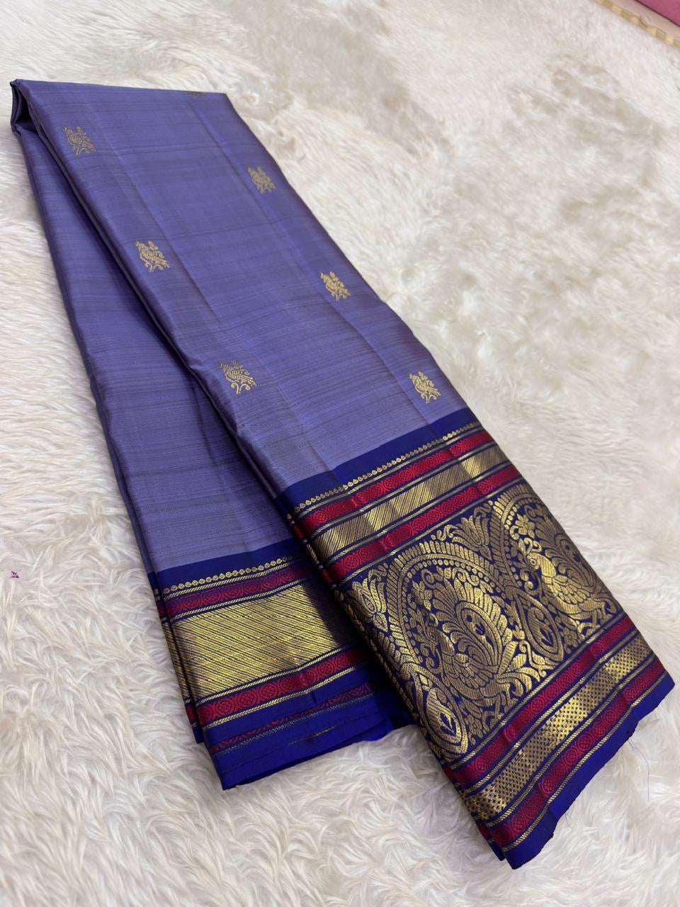 Mysterious purple Kanchipuram silk saree with ornate pallu and zari border – folded view
