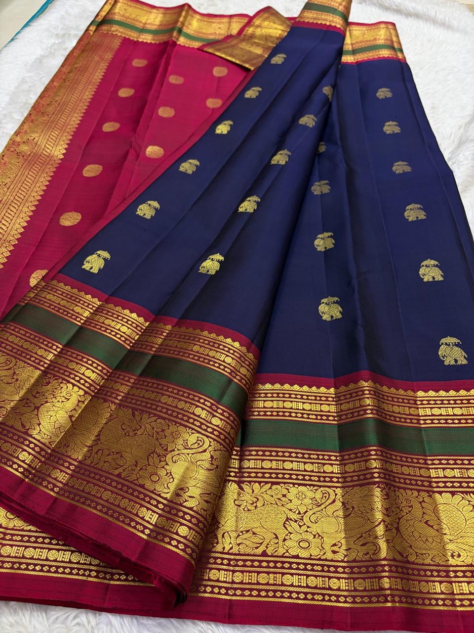 Close view of navy blue Kancheepuram silk body with ornate gold zari Yaanai Ambari elephant procession Butta