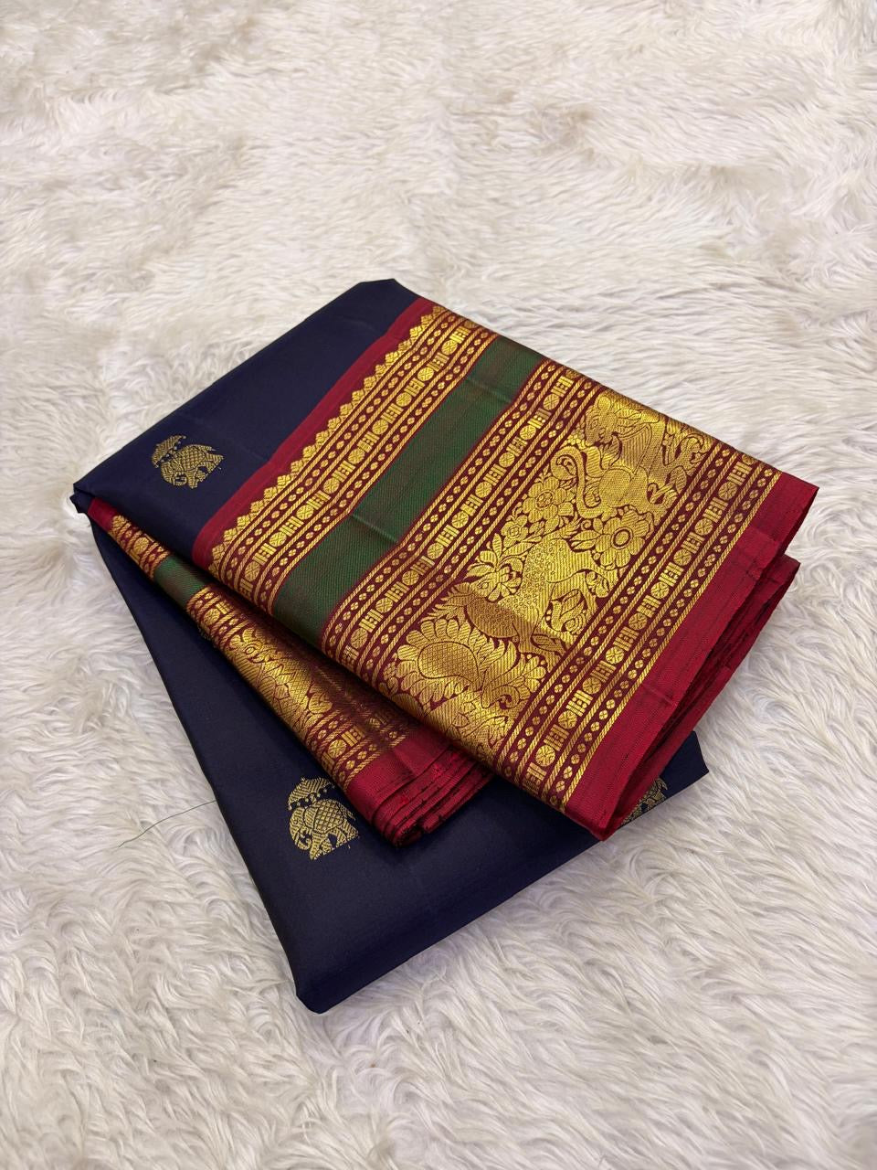 Deep red Vanasringaram gold zari border of navy blue Kancheepuram pure silk saree with elephant procession motif