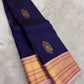 Deep navy Pure Silk Kanchipuram varisaipet saree with lotus-pink border and layered zari detailing.