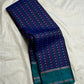 Full navy Kanchi Pattu saree with jewel-tone butta work, folded view