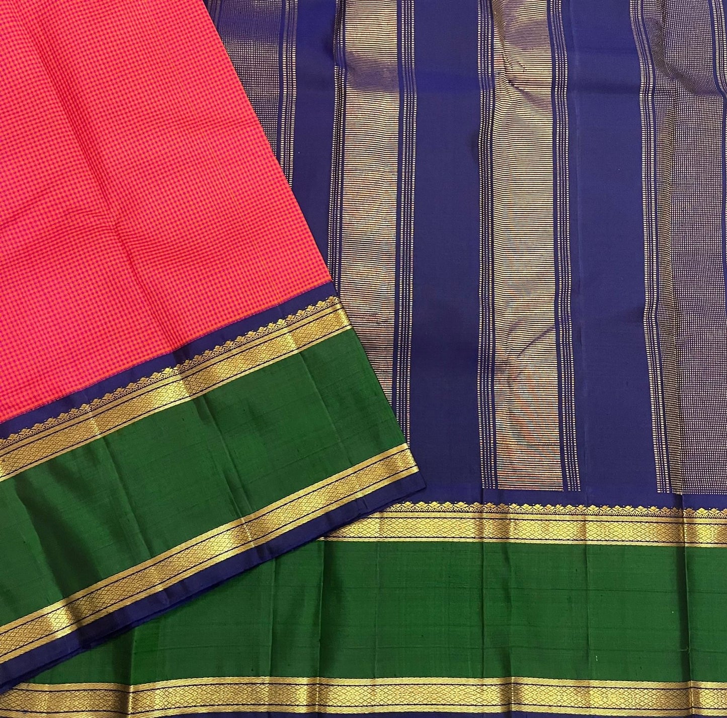 Pure Kanchipuram silk saree flat lay showing green border with gold zari and navy pallu stripes, shipped from New Jersey USA.