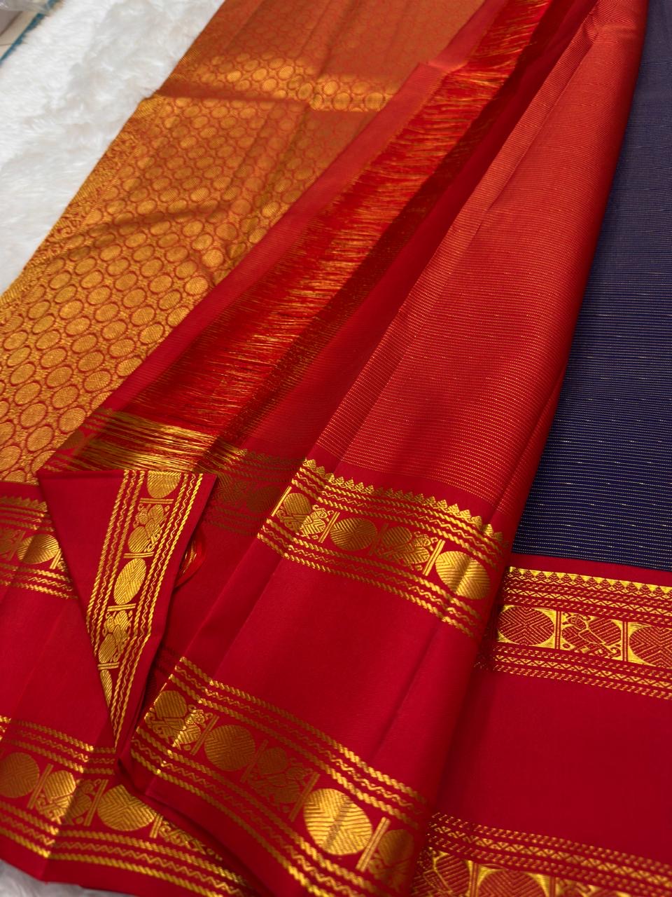 Pallu detail of deep navy Vairaoosi KanchiPattu silk saree with vermilion red zari border