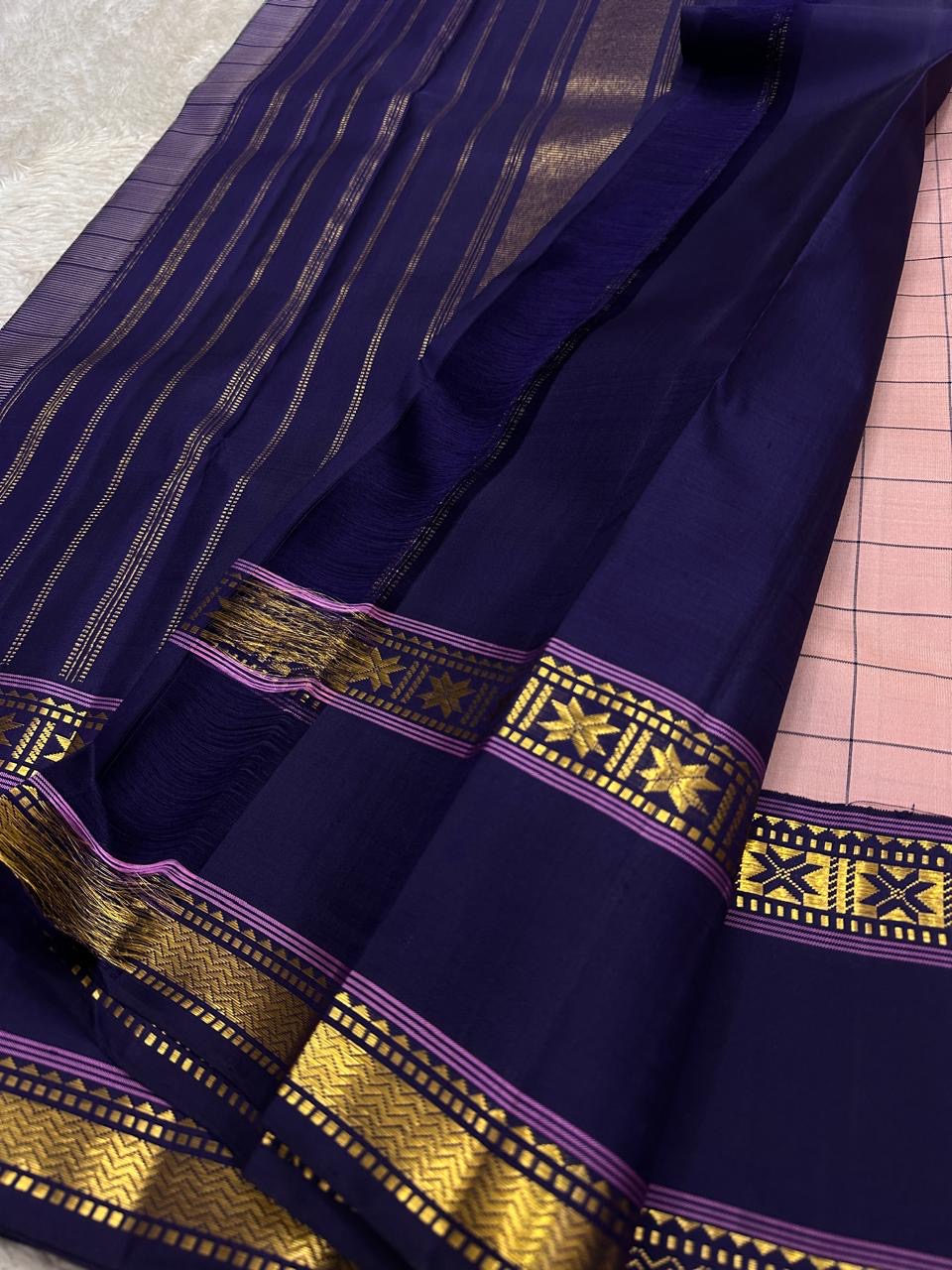 Close view of deep navy pallu with vertical zari woven stripes and a star motif border on pure Kanchipuram silk saree