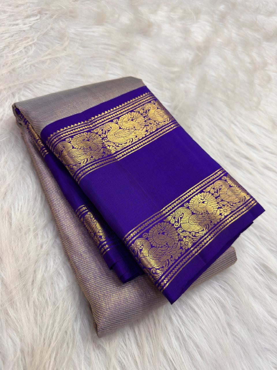 Handwoven pure silk Kanchipuram Rettapet saree in neelam blue with all-over gold zari lines.