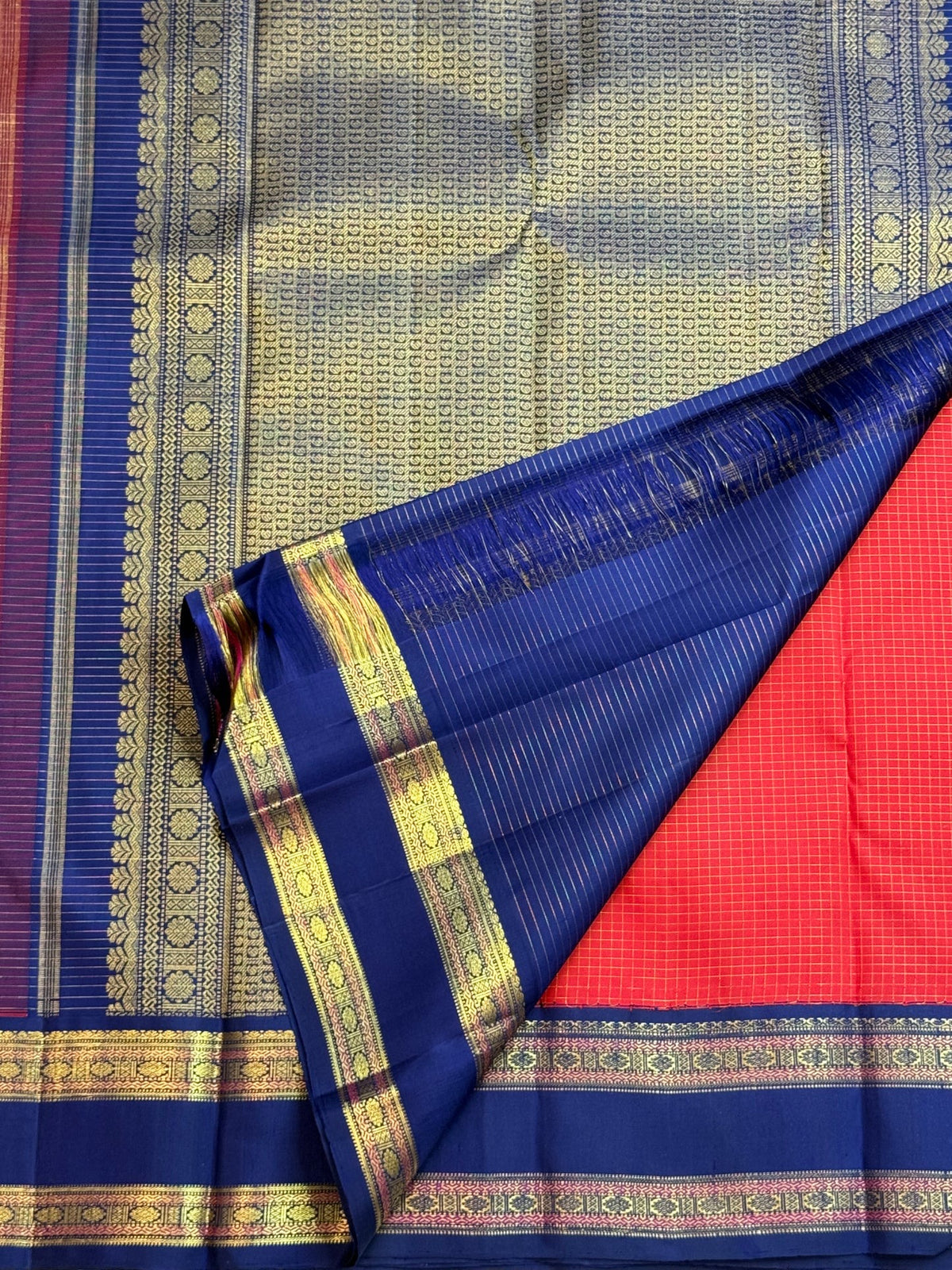 Neelam-blue Rettapet border with Rudhraksham-inspired motif bands on a deep vibrant red Pure Silk Kanchipuram saree.
