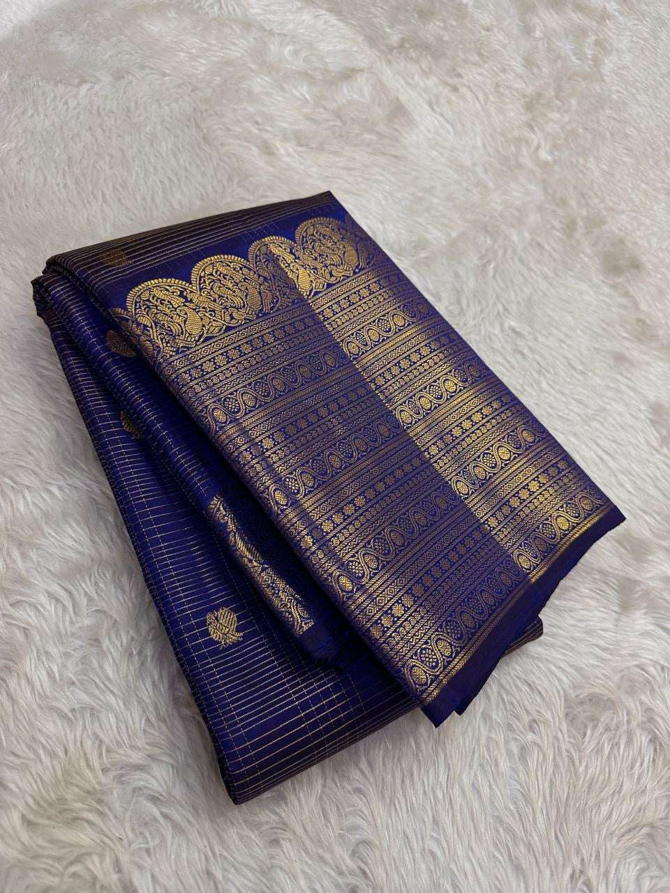 Fine classic-gold Zari Kattam crossing saturated Deep Neelam Blue Kanchipuram silk.