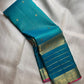 Teal-blue Pure Silk Kanjipuram Zari Kattam saree with fine gold grid and a stylised bird-motif border.