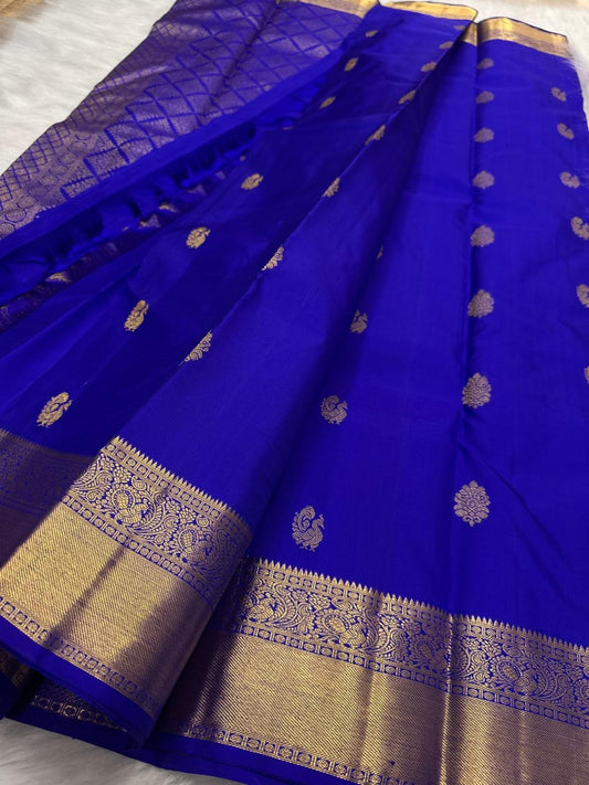 Scrolling floral classic-gold zari ornament across the broad traditional border.