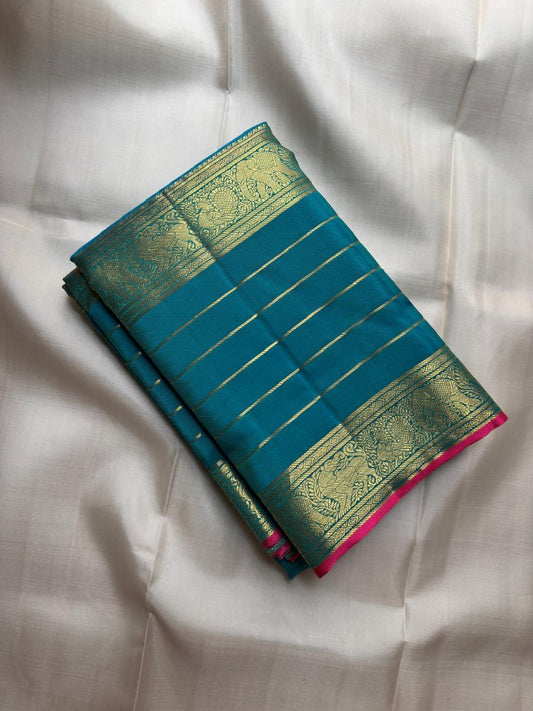 Teal Kanchipuram silk body with fine classic-gold zari lines forming a close ordered grid.