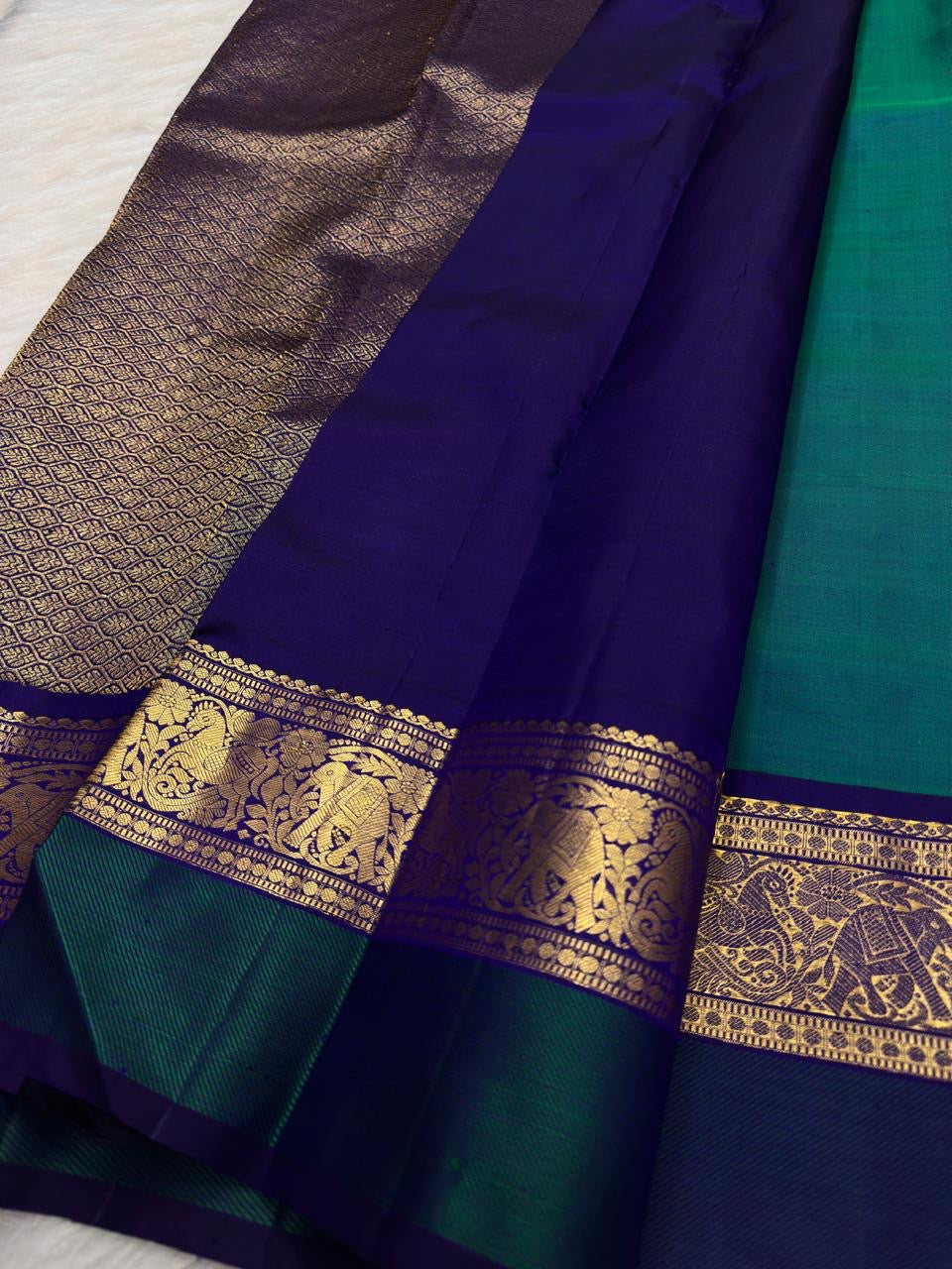 Neelam Blue Handwoven Pure Silk Kanchipuram Butta Saree with Teal Green Bird Motif Kaal Irangiya Gold Zari Border