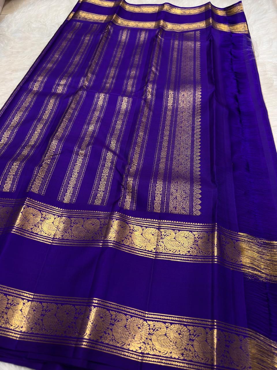 Layered gold Rettapet border on the blue silk saree.