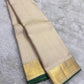 Thick antique gold zari woven border with floral and geometric motifs on off-white KanchiPattu saree