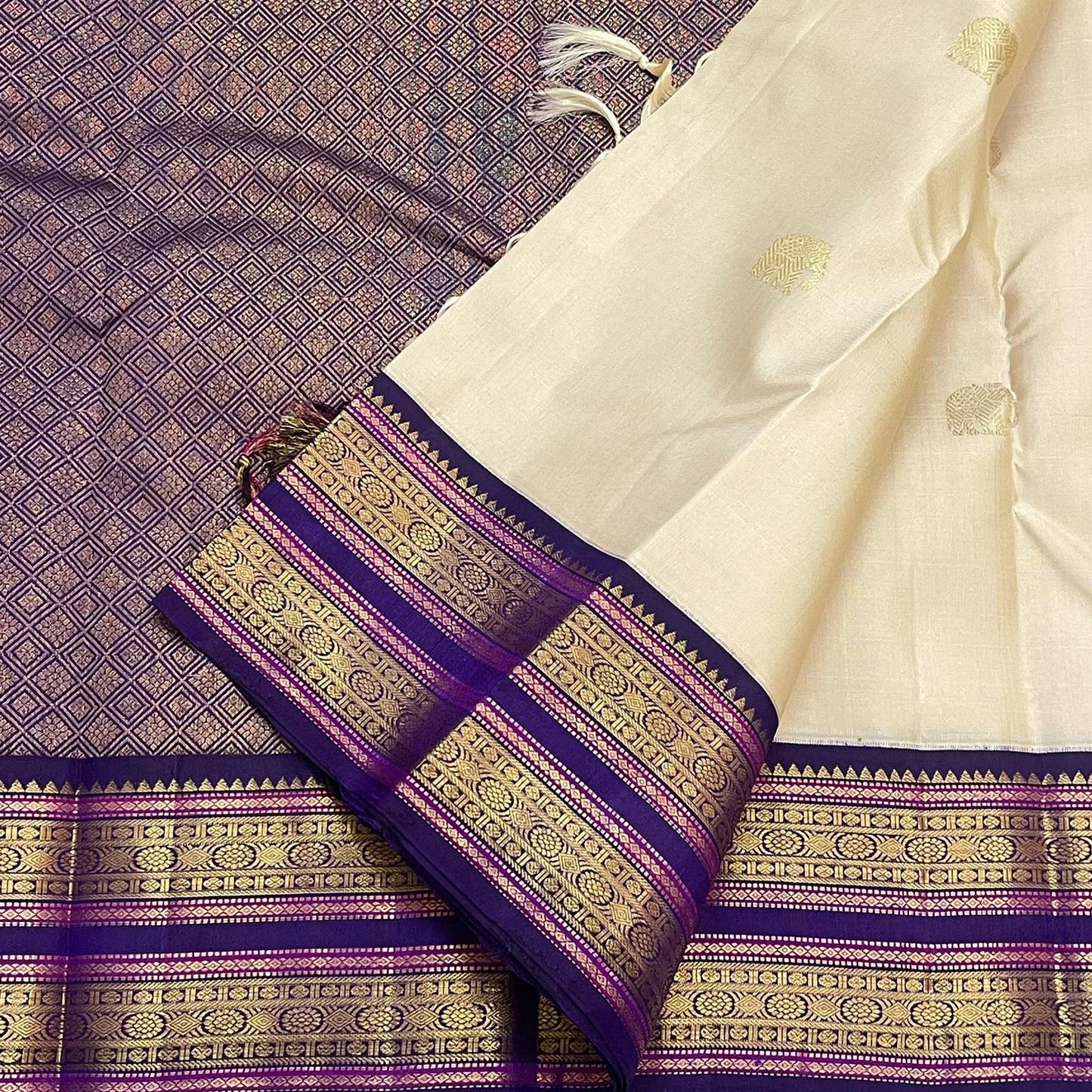 Off-white silk surface with gold zari elephant motif detail
