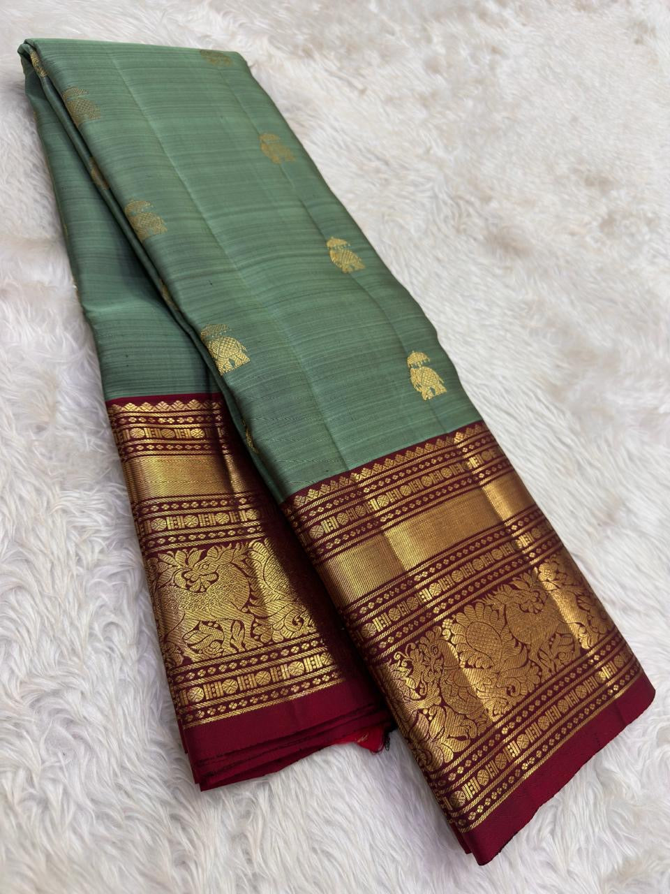 Handwoven olive green KanchiPattu pure silk saree with gold zari Yaanai Ambari Butta and deep red Vanasringaram border