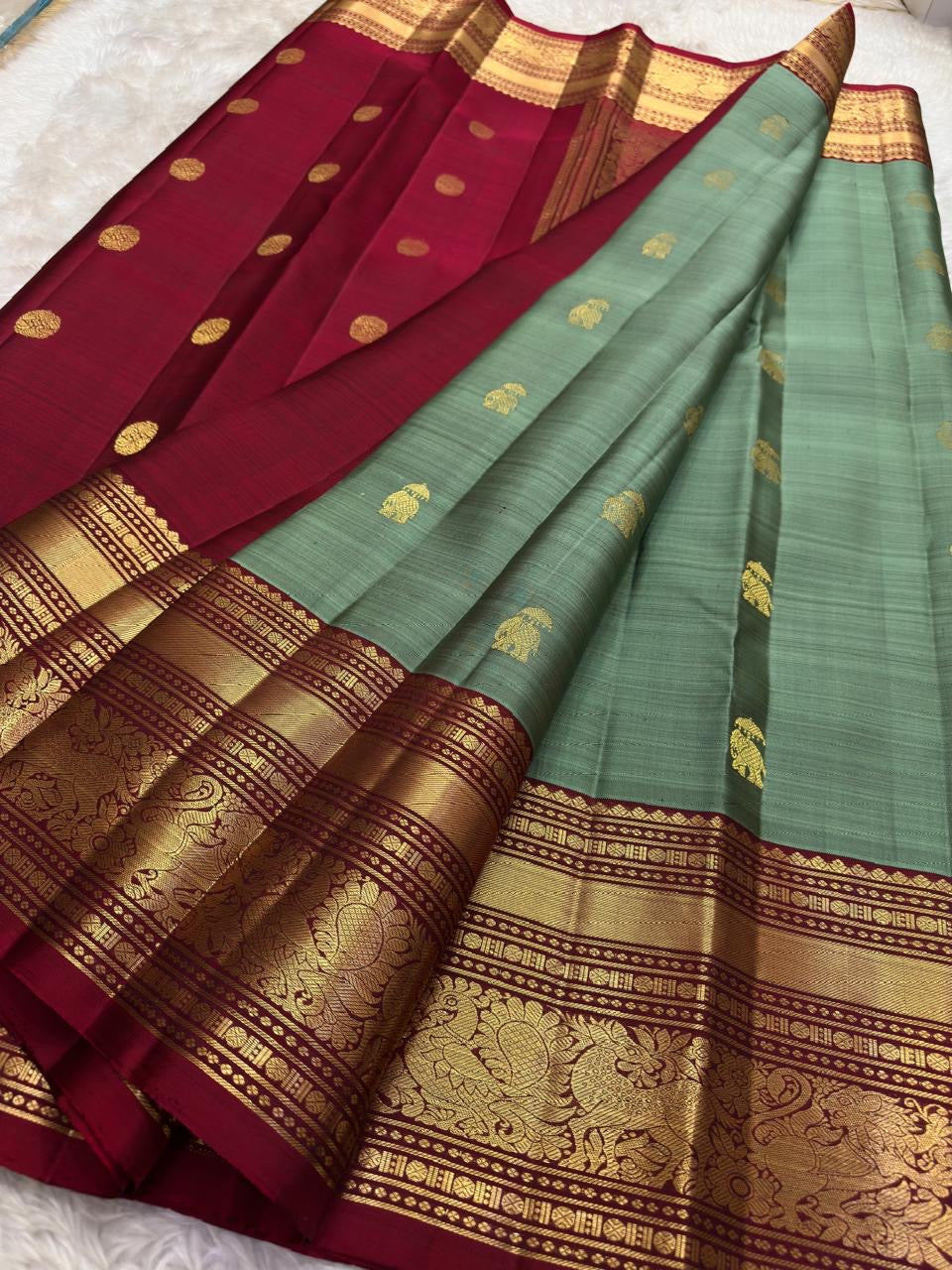 Detail of ornate gold zari Yaanai Ambari elephant procession Butta woven across olive green KanchiPattu silk body