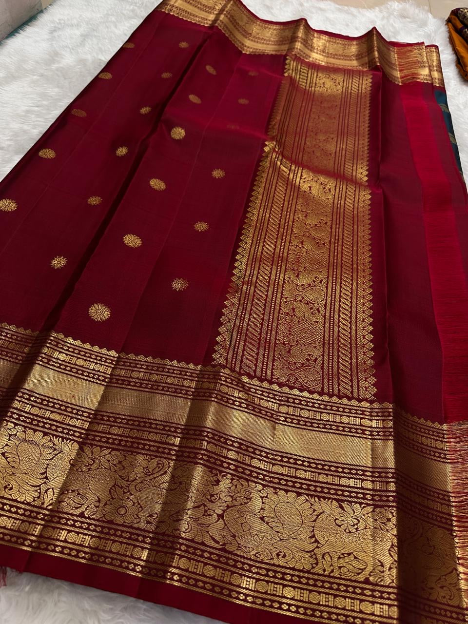 Deep red Vanasringaram gold zari border of olive green KanchiPattu pure silk saree with elephant procession motif