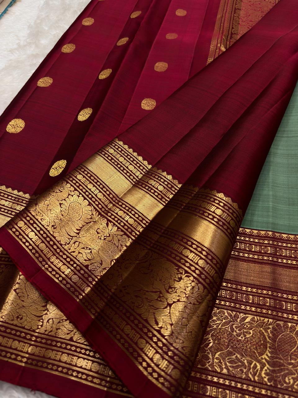 Rich deep red Vanasringaram gold zari pallu of olive green KanchiPattu pure silk saree