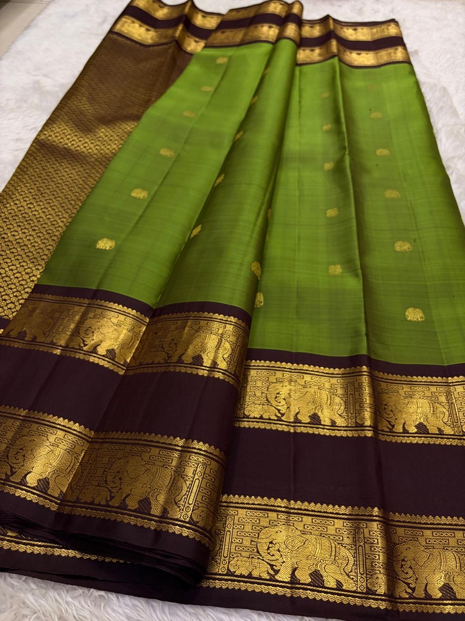 Olive green Kanchipuram silk saree gold zari butta detail on body