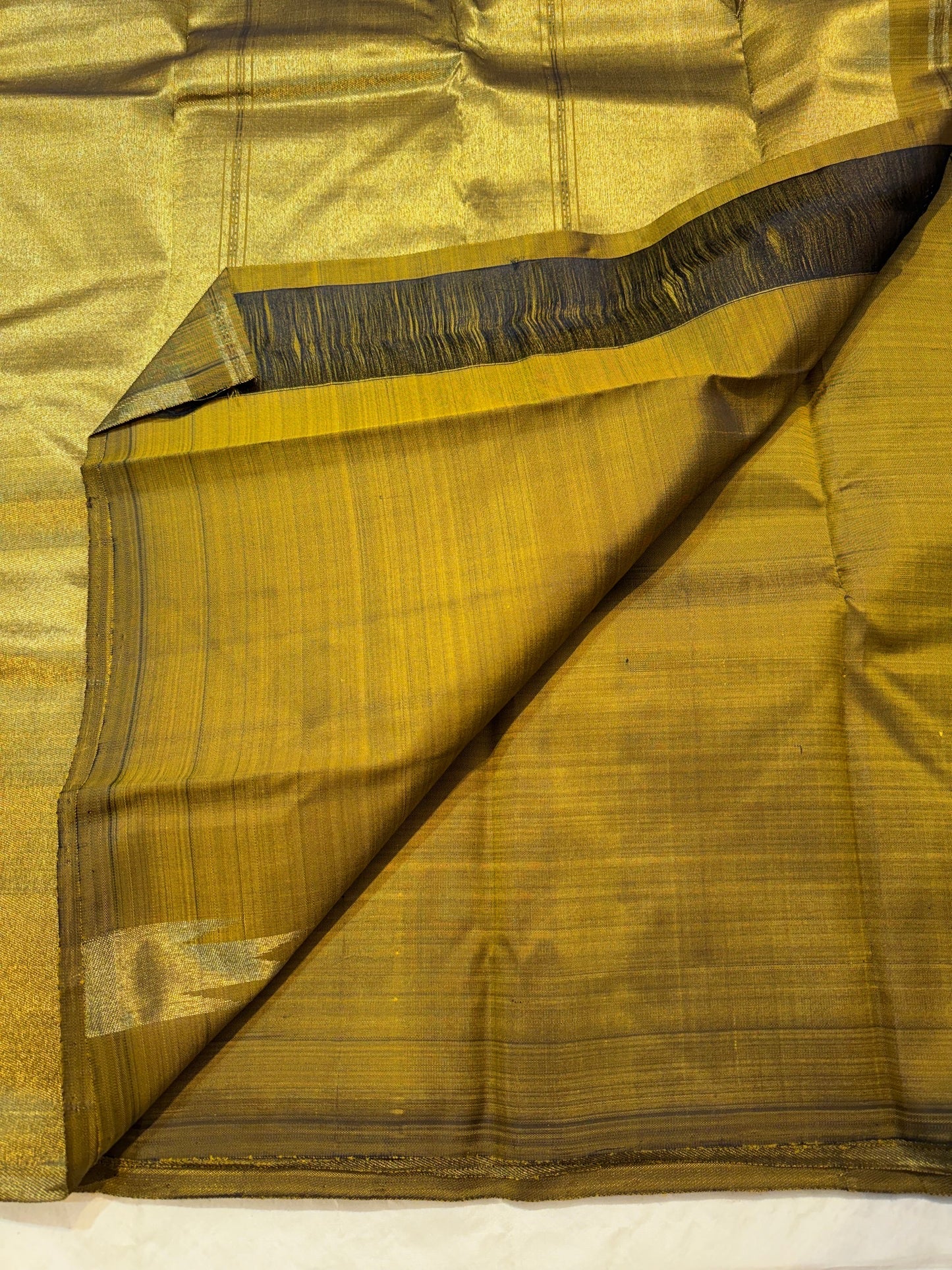 Close-up of ettukol antique copper zari border on olive green Kanchipuram pure silk saree — Idam Living