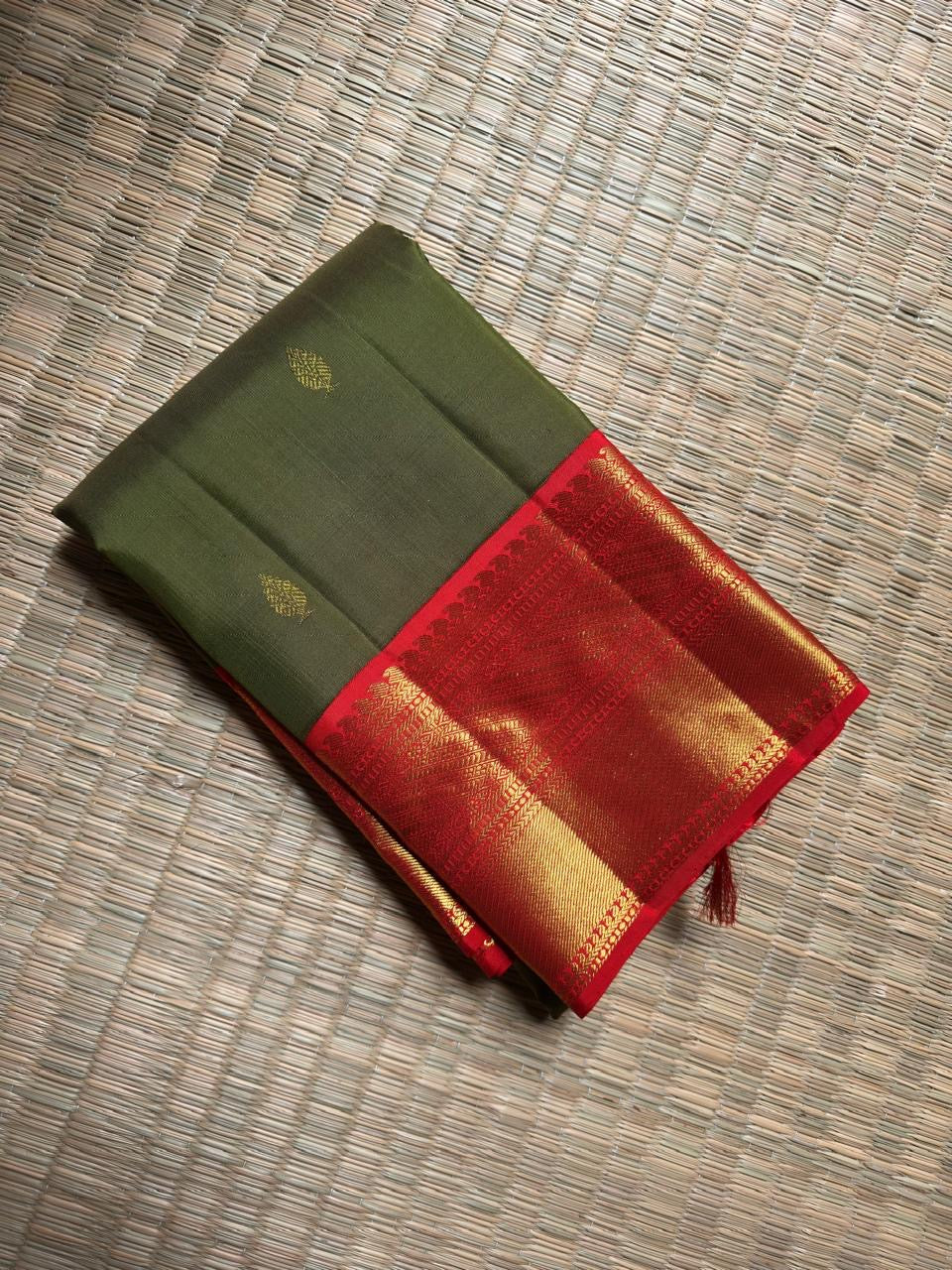 Olive Green Pure Silk Kanjivaram saree with gold-zari buttas.