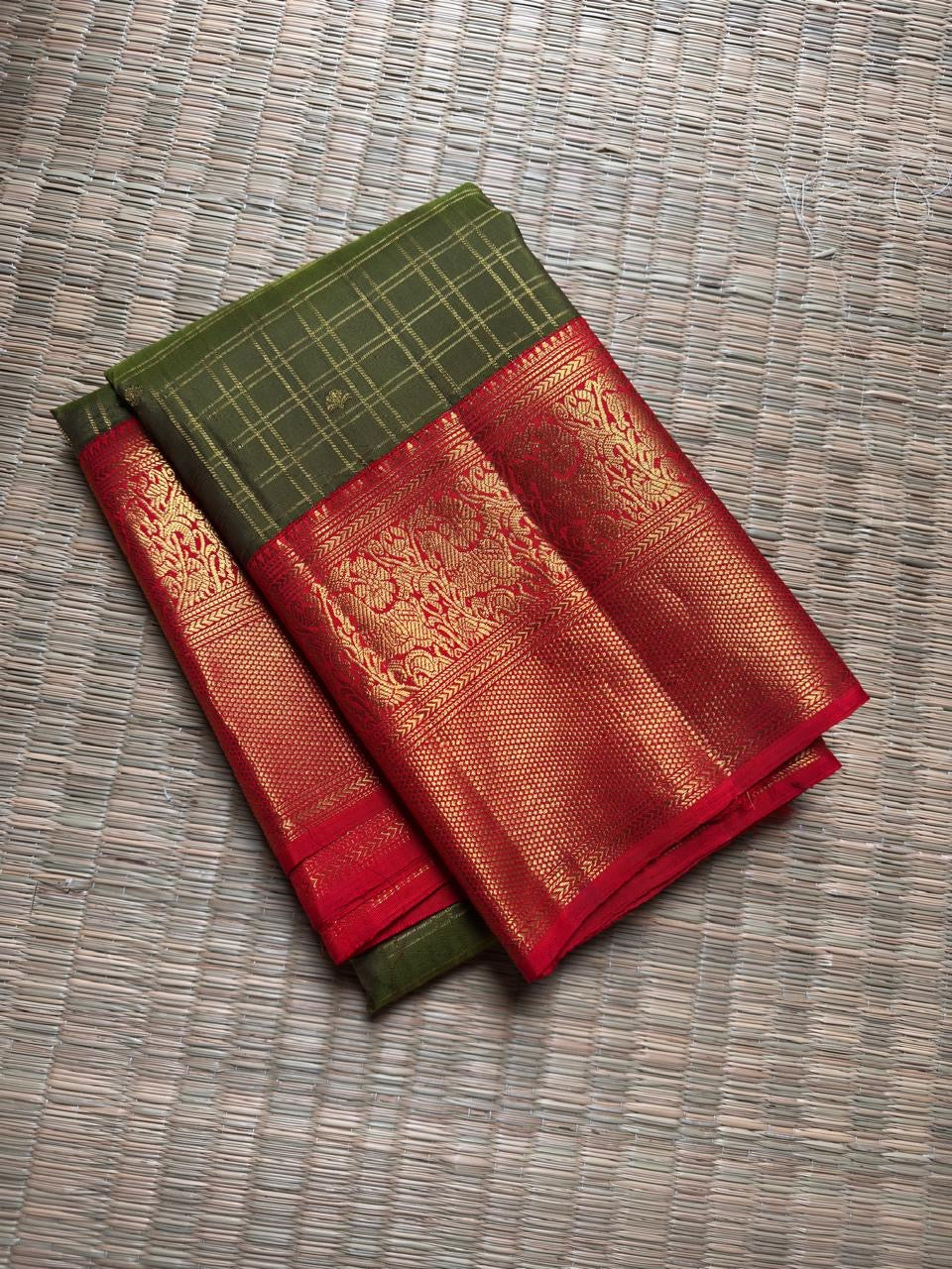 Olive Green Kanjivaram silk with petite gold-zari buttas.